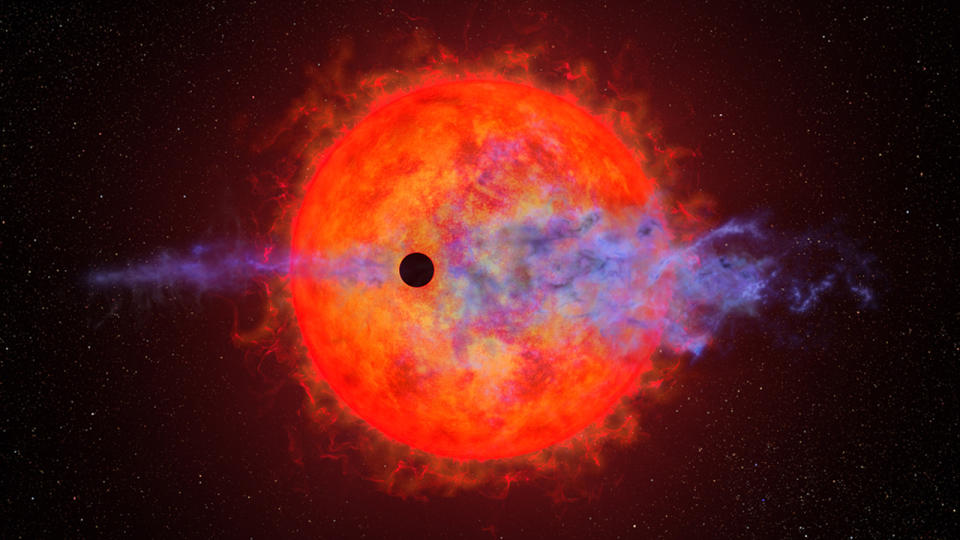 A fiery red dwarf star is seen in the background. In the foreground, a tiny black orb transits in front. Around the black orb is a purple hazy atmosphere that's blowing away on either side.