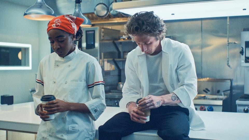 Ayo Edebiri and Jeremy Allen White, as Sydney and Carmy, in a restaurant kitchen.