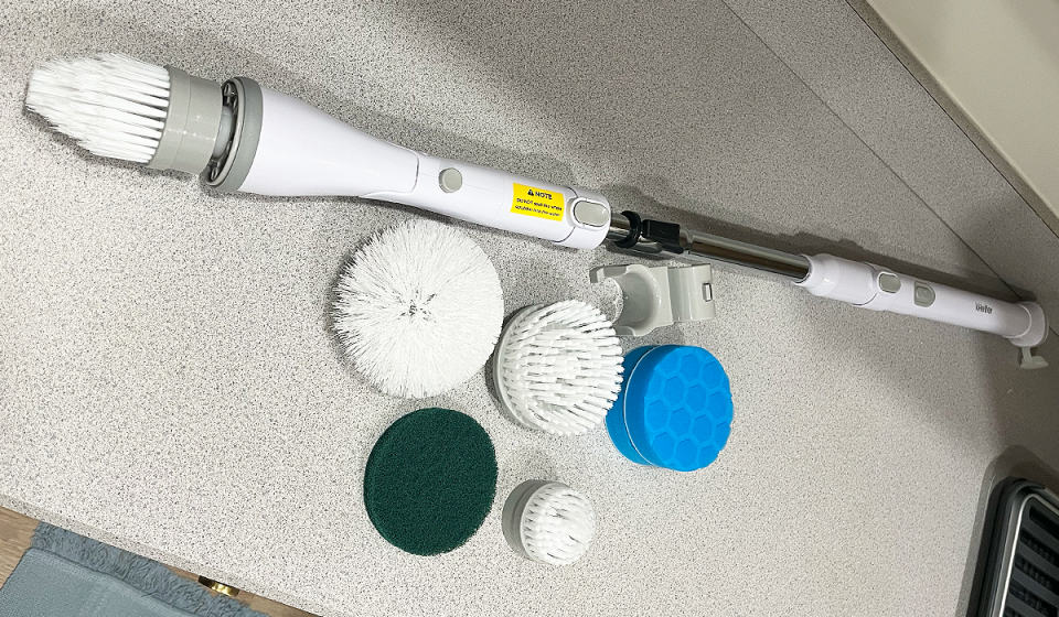 The kHelfer electric spin brush shown with all brushes and attachments.