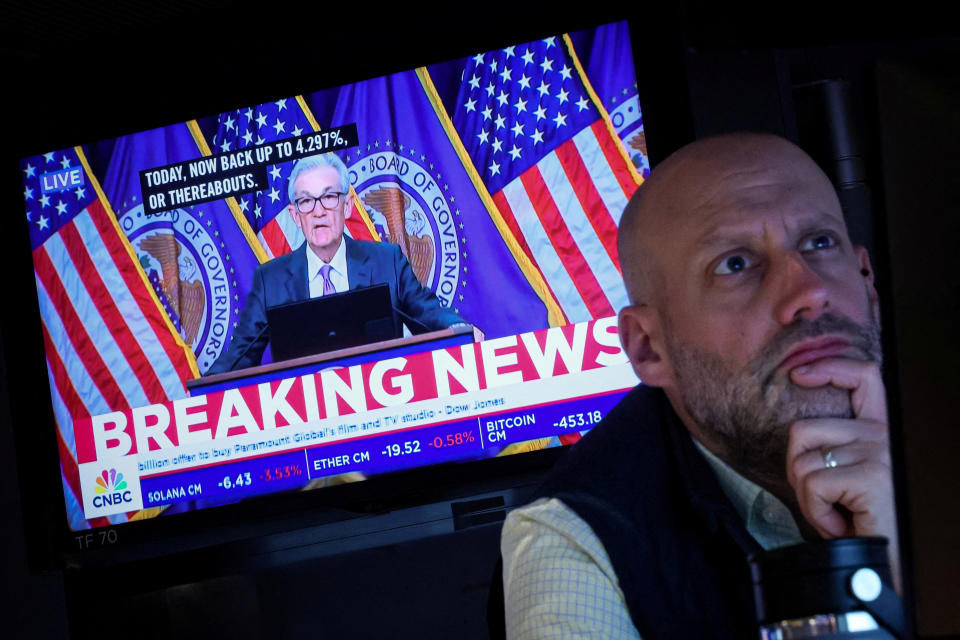 FILE PHOTO: A trader works, as a screen broadcasts a news conference by U.S. Federal Reserve Chair Jerome Powell following the Fed rate announcement, on the floor of the New York Stock Exchange (NYSE) in New York City, U.S., March 20, 2024.  REUTERS/Brendan McDermid/File Photo