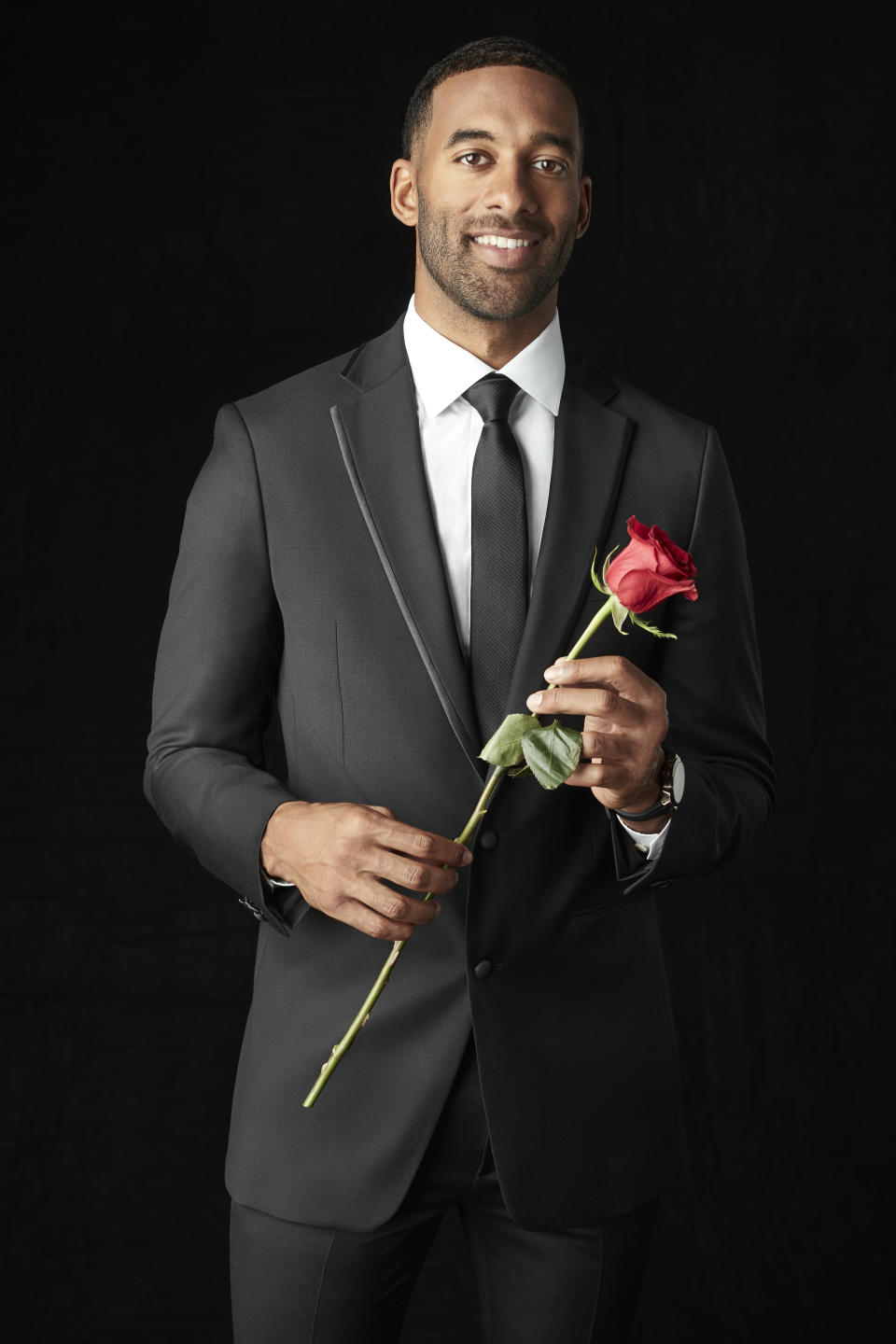 Matt James holding a rose.