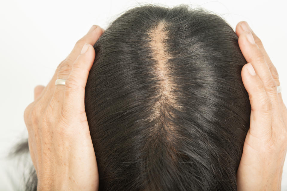 Woman parting her hair