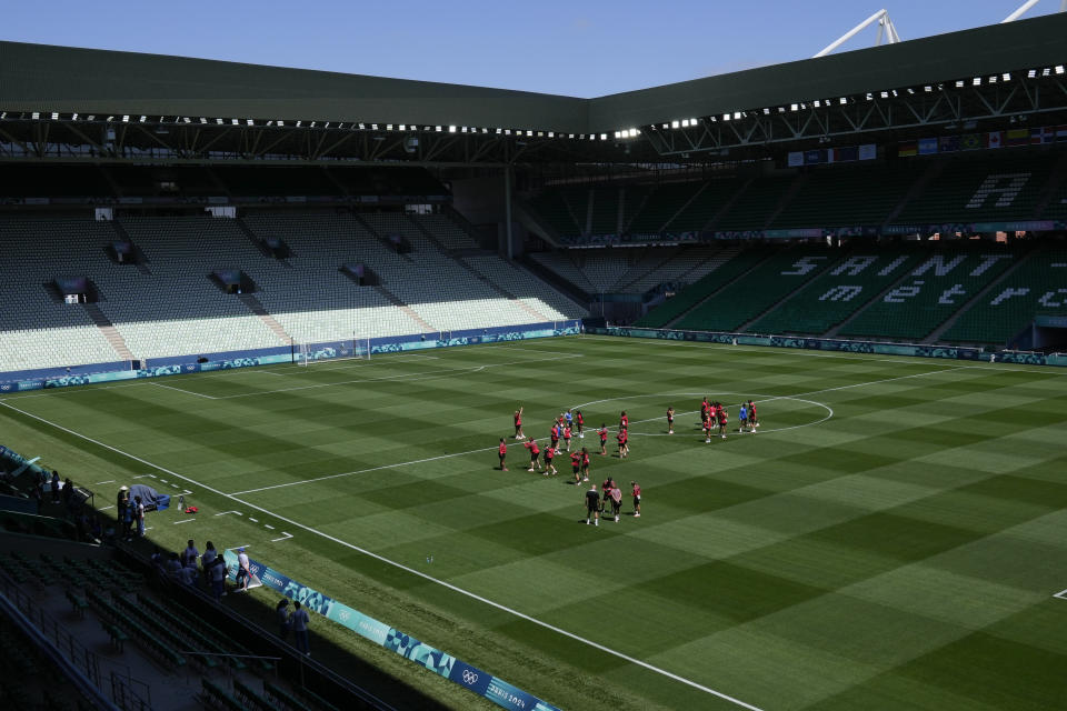 Canada's players walk on the pitch at Geoffroy-Guichard Stadium ahead of the 2024 Summer Olympics, Tuesday, July 23, 2024, in Saint-Etienne, France. Canada is scheduled to play New Zealand on Thursday, July 25. (AP Photo/Silvia Izquierdo)