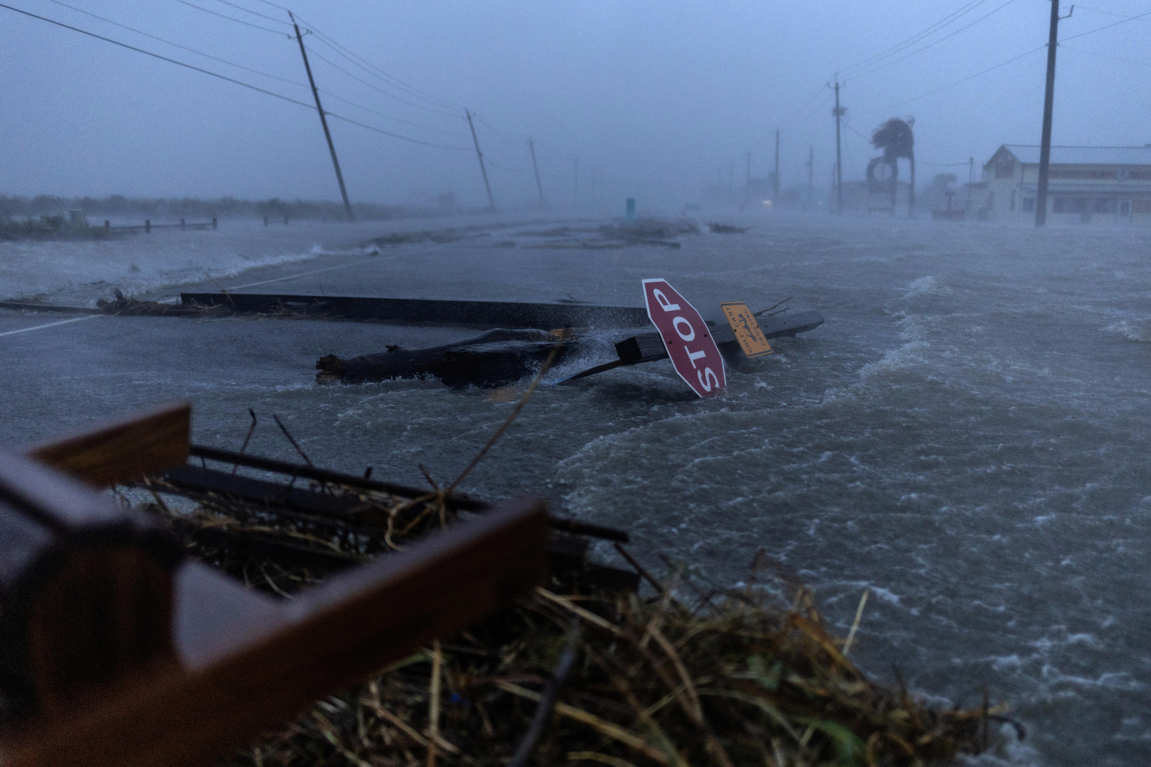 Debris and flood waters from Hurricane Beryl cover the main roadway in Surfside Beach, Texas.