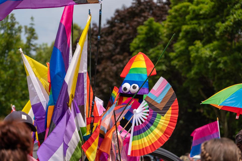 Vendors sell flags, buttons and other apparel at the Rochester Pride Parade.