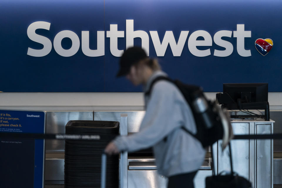 FILE - A traveler walks through the Southwest Airlines ticketing counter area at the Los Angeles International Airport in Los Angeles, April 18, 2023. Federal officials are investigating an incident on July 14, 2024, in which a Southwest jet flew as low as 150 feet (45 meters) over water while it was still several miles from its intended landing spot at the airport in Tampa, Fla. (AP Photo/Jae C. Hong, File)