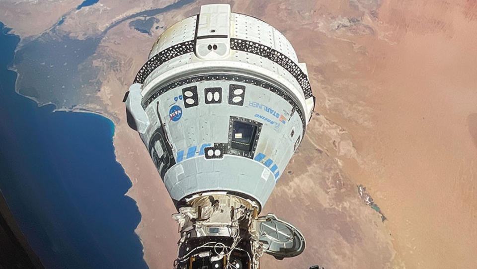 Boeing's white and blue Starliner spacecraft docked at the International Space Station in June 2024.