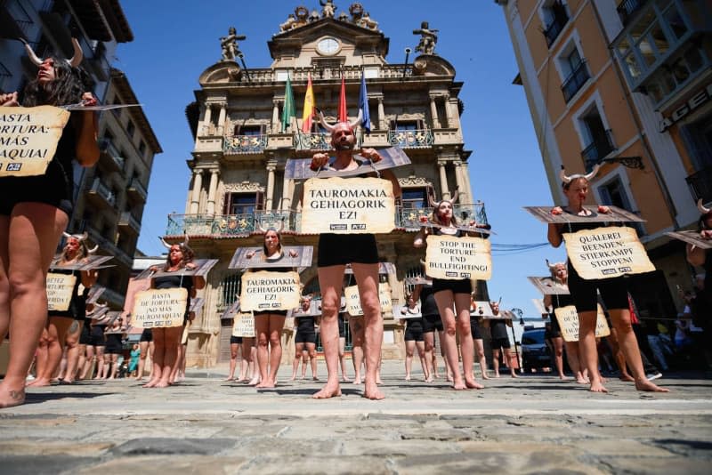 Protesters with their faces stained with fake blood and chains on their wrists, take part in a demonstration against bullfights, ahead of the San Fermin 2024 festivities. The famous running of the bulls event in Pamplona, northern Spain, kicked off on Saturday, despite protests from animal rights activists. Elsa A Bravo/SOPA Images via ZUMA Press Wire/dpa