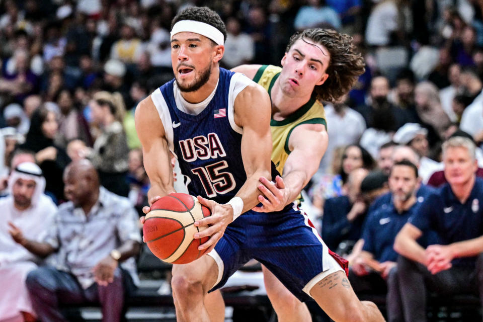 Australia's guard #03 Josh Giddey marks USA's guard #15 Devin Booker during the Basketball Showcase friendly match between the United States and Australia at Etihad Arena in Abu Dhabi on July 15, 2024. (Photo by Giuseppe CACACE / AFP) (Photo by GIUSEPPE CACACE/AFP via Getty Images)