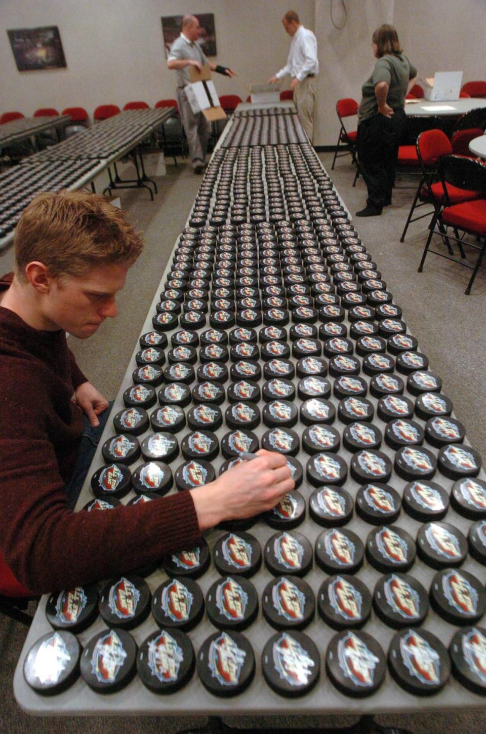 Carolina Hurricanes rookie Eric Staal signs one of over 2,000 pucks for season-ticket holders following practice at the RBC Center on Thursday, April 1, 2004. The rookie from Thunder Bay, Ontario has had to adjust to life in the NHL and a new town.