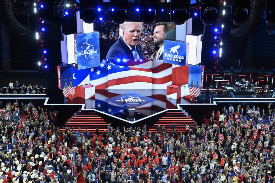 TOPSHOT - Former US President and 2024 Republican presidential candidate Donald Trump is displayed on a screen as he arrives during the second day of the 2024 Republican National Convention at the Fiserv Forum in Milwaukee, Wisconsin, July 16, 2024. Days after he survived an assassination attempt Donald Trump won formal nomination as the Republican presidential candidate and picked right-wing loyalist J.D. Vance for running mate, kicking off a triumphalist party convention in the wake of last weekend's failed assassination attempt. (Photo by Pedro UGARTE / AFP) (Photo by PEDRO UGARTE/AFP via Getty Images)