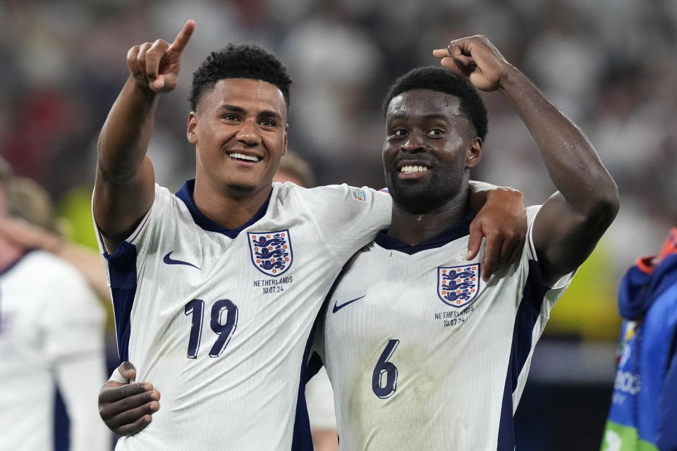 England's Ollie Watkins, left, celebrates with England's Marc Guehi after winning a semifinal match between the Netherlands and England at the Euro 2024 soccer tournament in Dortmund, Germany, Wednesday, July 10, 2024. (AP Photo/Frank Augstein)