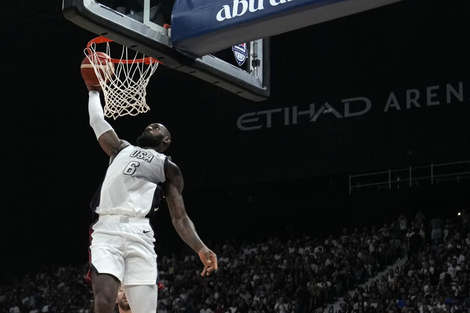 United States' LeBron James scores during an exhibition basketball match between Serbia and the United States at the USA Basketball Showcase, ahead of the 2024 Paris Olympic basketball tournament, in Abu Dhabi, United Arab Emirates, Wednesday, July 17, 2024. (AP Photo/Altaf Qadri)