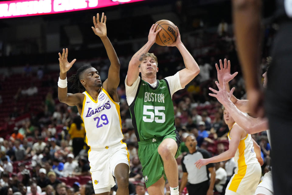 Jul 15, 2024; Las Vegas, NV, USA; Boston Celtics guard Baylor Scheierman (55) drives the ball against Los Angeles Lakers guard Sean East II (29) during the second half at Thomas & Mack Center. Mandatory Credit: Lucas Peltier-USA TODAY Sports