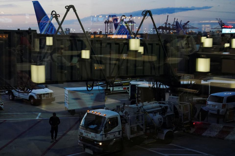 A person is seen beneath a jet bridge at Terminal C in Newark International Airport, after United Airlines and other airlines grounded flights due to a worldwide tech outage caused by an update to Crowdstrike's "Falcon Sensor" software which crashed Microsoft Windows systems, in Newark, New Jersey, U.S., July 19, 2024.