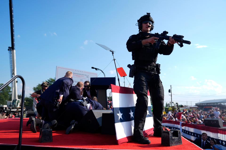 Republican presidential candidate former President Donald Trump is covered by U.S. Secret Service agents at a campaign rally, Saturday, July 13, 2024, in Butler, Pa. (AP Photo/Evan Vucci)