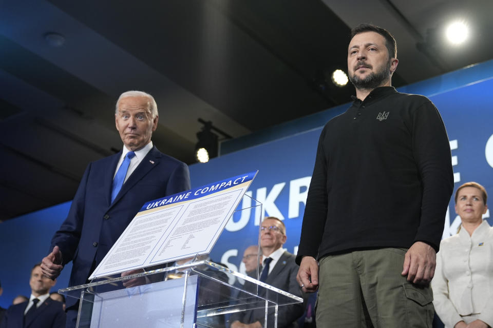 President Joe Biden, left, and President of Ukraine Volodymyr Zelenskyy pose alongside the Ukraine Compact during an event on the sidelines of the NATO Summit in Washington, Thursday, July 11, 2024. Biden launched the Ukraine Compact, signed by 25 countries and the European Union, as part of a commitment to Ukraine's long term security. (AP Photo/Susan Walsh)