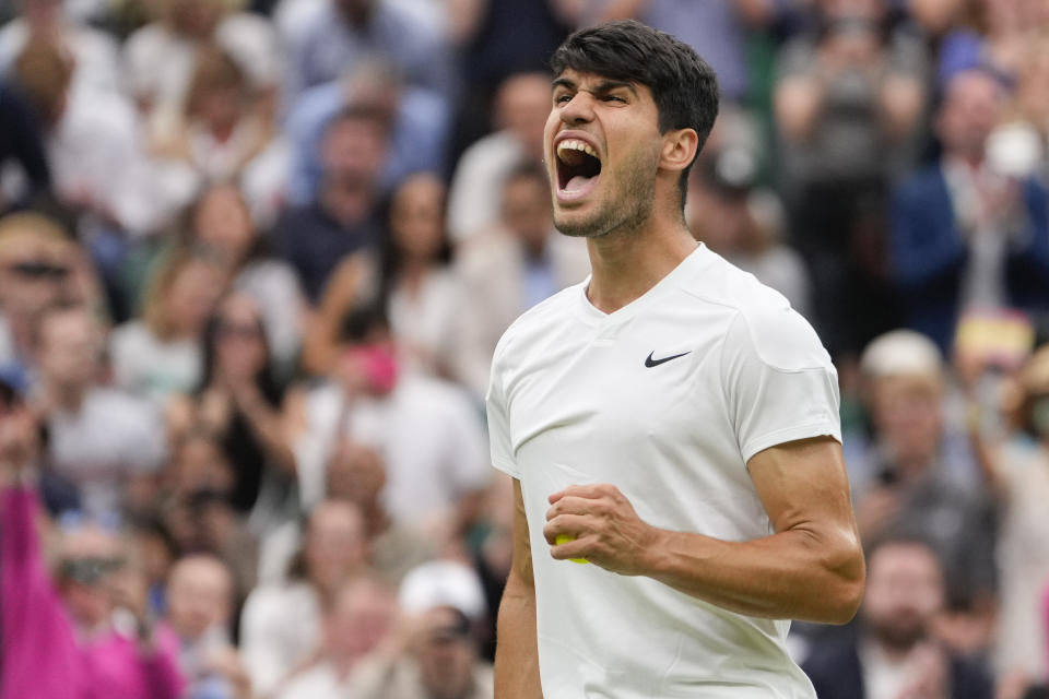 Carlos Alcaraz of Spain reacts during his fourth round match against Ugo Humbert of France at the Wimbledon tennis championships in London, Sunday, July 7, 2024. (AP Photo/Alberto Pezzali)