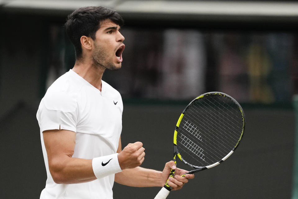 Carlos Alcaraz of Spain reacts during his quarterfinal match against Tommy Paul of the United States at the Wimbledon tennis championships in London, Tuesday, July 9, 2024. (AP Photo/Kirsty Wigglesworth)