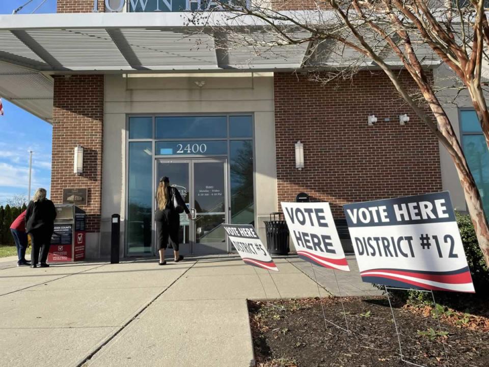 Woman enters a New Jersey polling location inside a mall to cast a ballot in the November 8, 2022 midterm election while two other women examine a ballot drop box. Photo by Ernie Journeys via Unsplash.