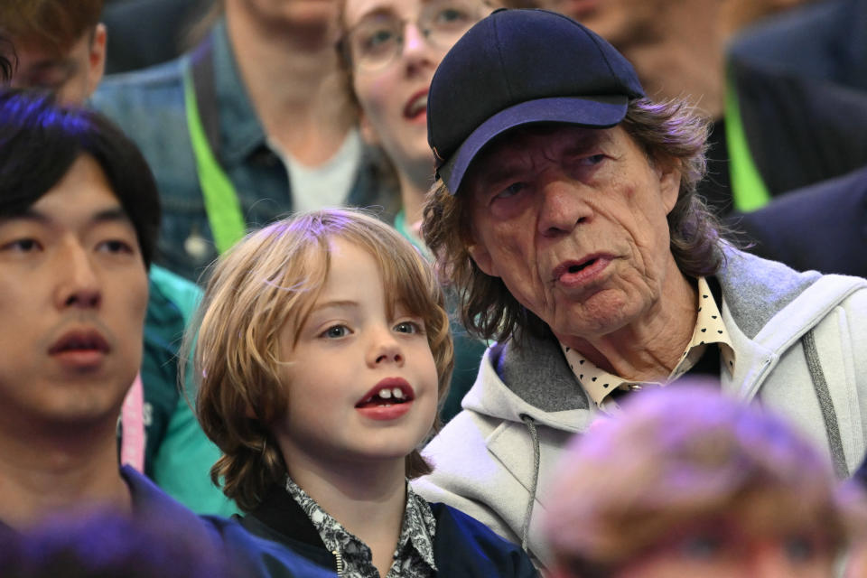 British singer Sir Mick Jagger (R) of The Rolling Stones band and his son Deveraux Octavian Basil Jagger attend fencing competitions during the Paris 2024 Olympic Games at the Grand Palais in Paris, on July 27, 2024. (Photo by Fabrice COFFRINI / AFP) (Photo by FABRICE COFFRINI/AFP via Getty Images)