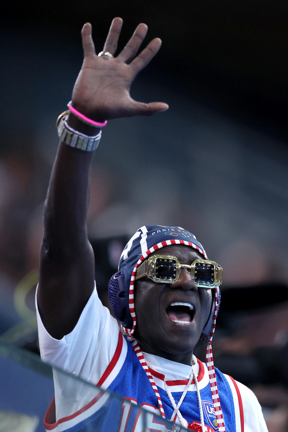 PARIS, FRANCE - JULY 31: American Rapper, Flavor Flav, shows his support during the Women's Preliminary Round Group B match between Team Italy and Team United States on day five of the Olympic Games Paris 2024 at Aquatics Centre on July 31, 2024 in Paris, France. (Photo by Clive Rose/Getty Images)