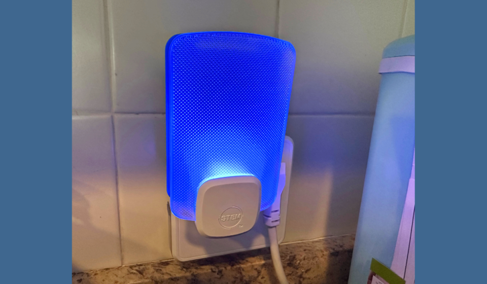 STEM light trap plugged into outlet and glowing blue light