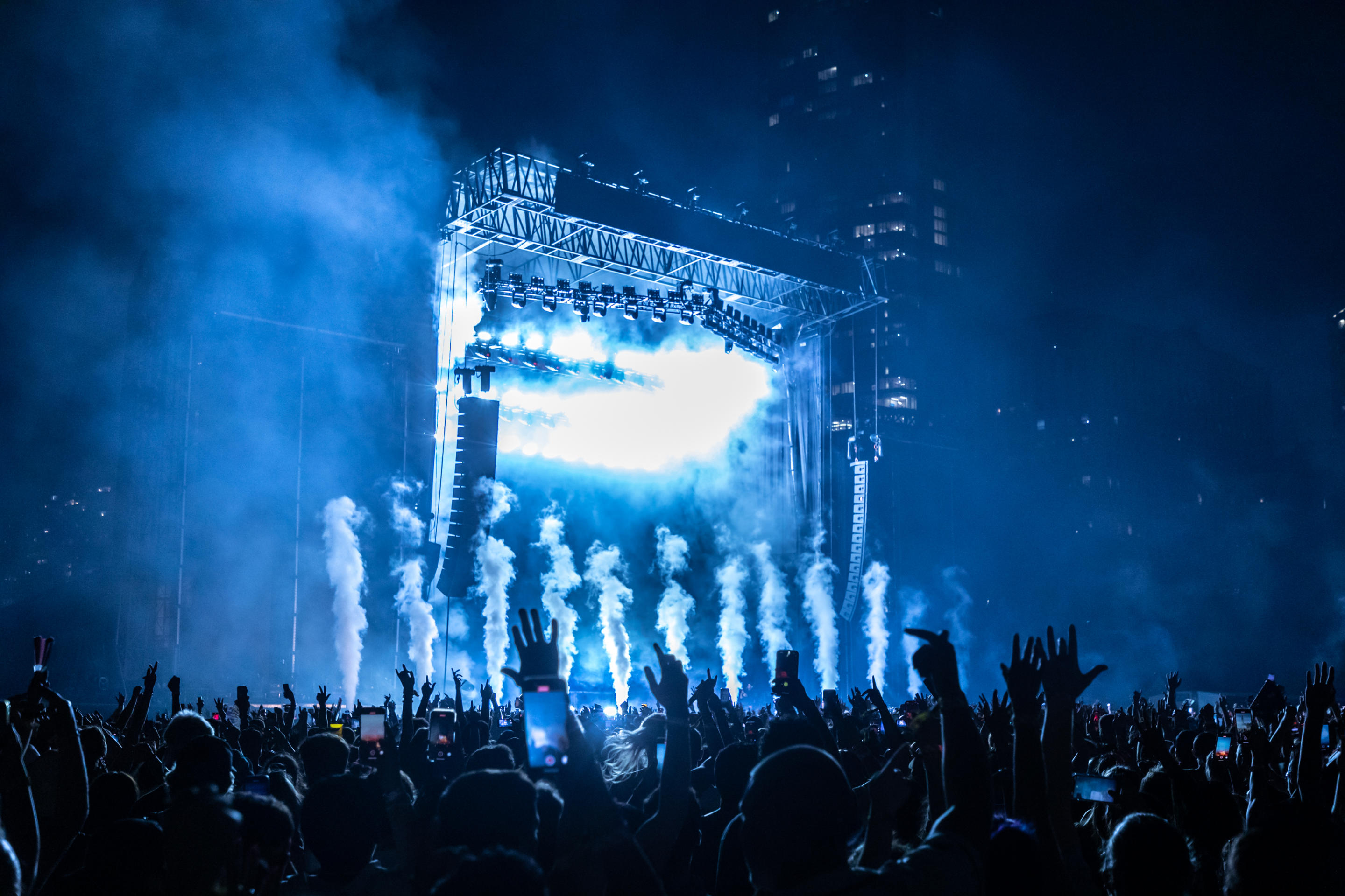 Crowds are lit by the stage lights during Zedd at Lollapalooza at Grant Park in Chicago.