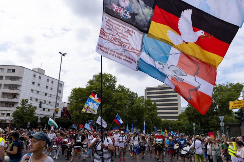 Supporters take part in the demonstration of the lateral thinking movement "Unity and justice and freedom". Carsten Koall/dpa