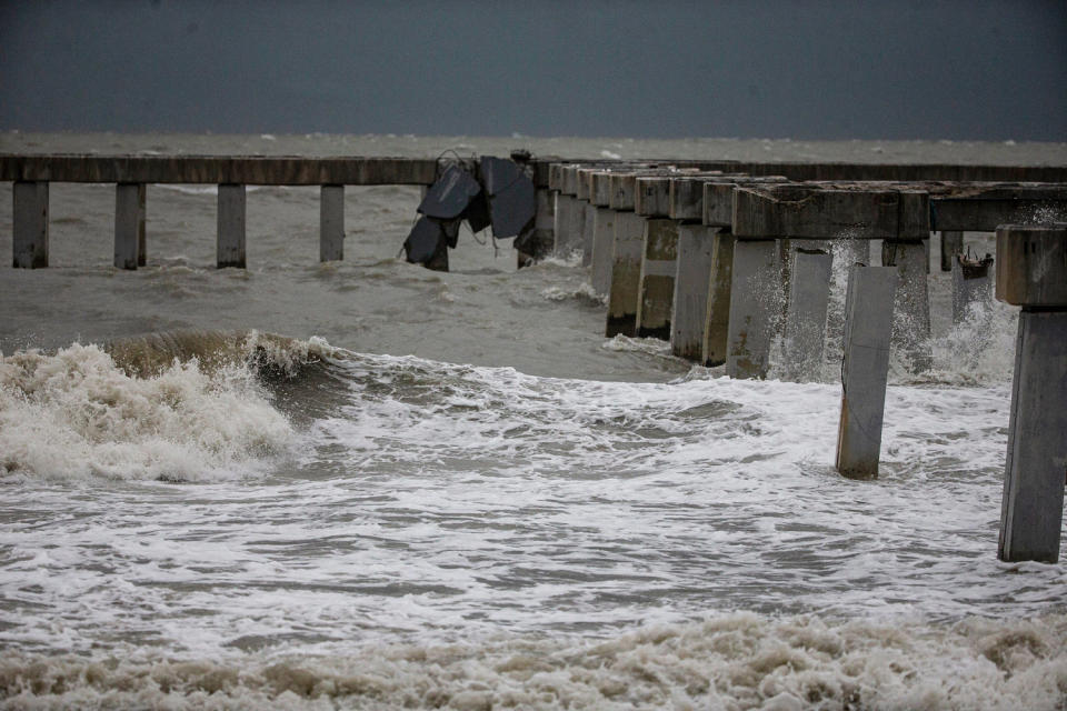 Stormy waters near a dock (Andrew West / The News-Press via USA Today Network)