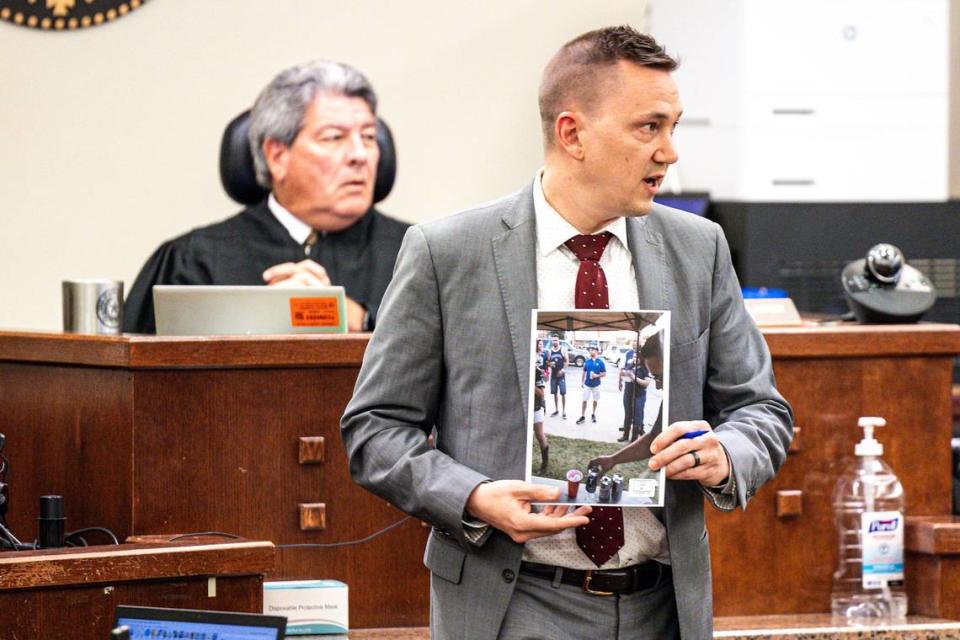 Assistant Criminal District Attorney Peter Gieseking displays a piece of evidence to the jury during the murder retrial of Marvin Rodriguez in 396th District Court at Tim Curry Criminal Justice Center in Fort Worth on Thursday, Aug. 1, 2024. The homicide occurred while Rodriguez and his family were tailgating outside AT&T Stadium in Arlington after a Cowboys game in 2015.