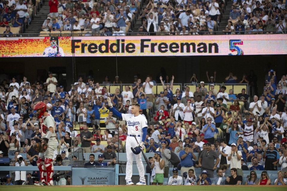 Freddie Freeman waves to the stands after a standing ovation before his first at-bat Monday.