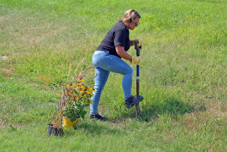 Ramona Schatzer demonstrates Monday on her Hartsburg property a safe location to dig following a call to 811, which contacted utility providers to mark and flag utility lines. While Schatzer works for Ameren Missouri, a utility company never will conduct the digging for a property owner that calls 811.