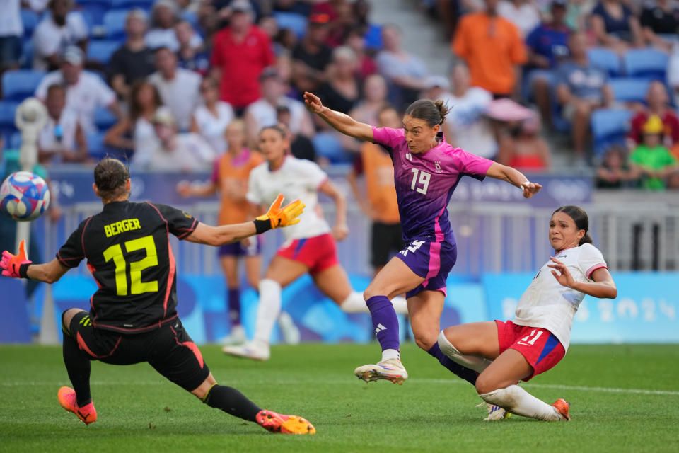 LYON, FRANCE - AUGUST 06: Sophia Smith #11 of the United States beats Ann-Katrin Berger #12 and Felicitas Rauch #19 of Germany to score during extra time of the Women's semifinal match during the Olympic Games Paris 2024 at Stade de Lyon on August 06, 2024 in Lyon, France. (Photo by John Todd/ISI/Getty Images)