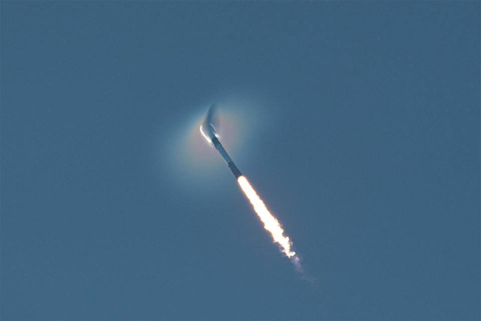 The Falcon 9 compresses the air ahead of it as the booster powers its way out of the dense lower atmosphere. / Credit: William Harwood/CBS News