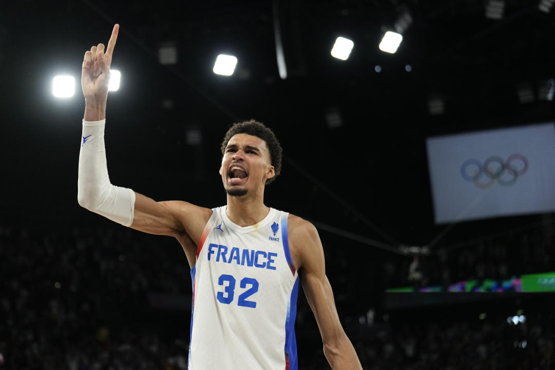 Victor Wembanyama (32), of France celebrates after beating Germany during a men's semifinals basketball game at Bercy Arena at the 2024 Summer Olympics, Thursday, Aug. 8, 2024, in Paris, France. (AP Photo/Mark J. Terrill)