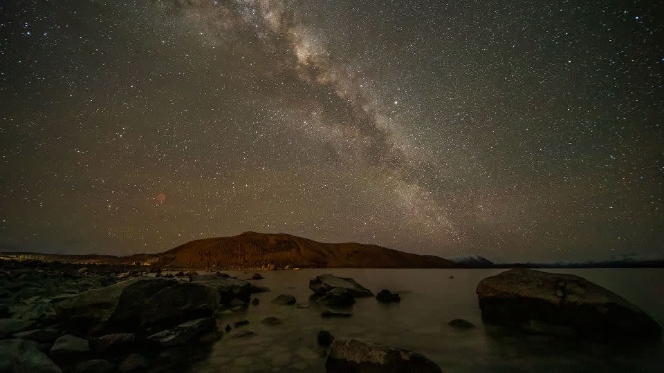 The Milky Way appears in the sky above Lake Takapō in the Mackenzie Country, South Island, New Zealand. - Sanka Vidanagama/NurPhoto/Getty Images