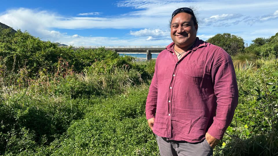 Rawiri Manawatu, head of Te Rūnanga o Kaikōura, stands by the Oaro River where his team is cleaning out the waterway and planting native trees to restore the local ecosystem. - Alaa Elassar/CNN