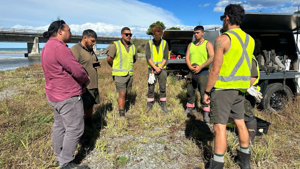 The Te Rūnanga o Kaikōura team blessing the land in Kaikōura, where they spend the day cleaning out a river. - Alaa Elassar/CNN