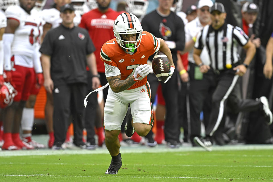 MIAMI GARDENS, FL - NOVEMBER 18:  Miami wide receiver Xavier Restrepo (7) runs after a reception in the first quarter as the Miami Hurricanes faced the Louisville Cardinals on November 18, 2023, at Hard Rock Stadium in Miami Gardens, Florida. (Photo by Samuel Lewis/Icon Sportswire via Getty Images)