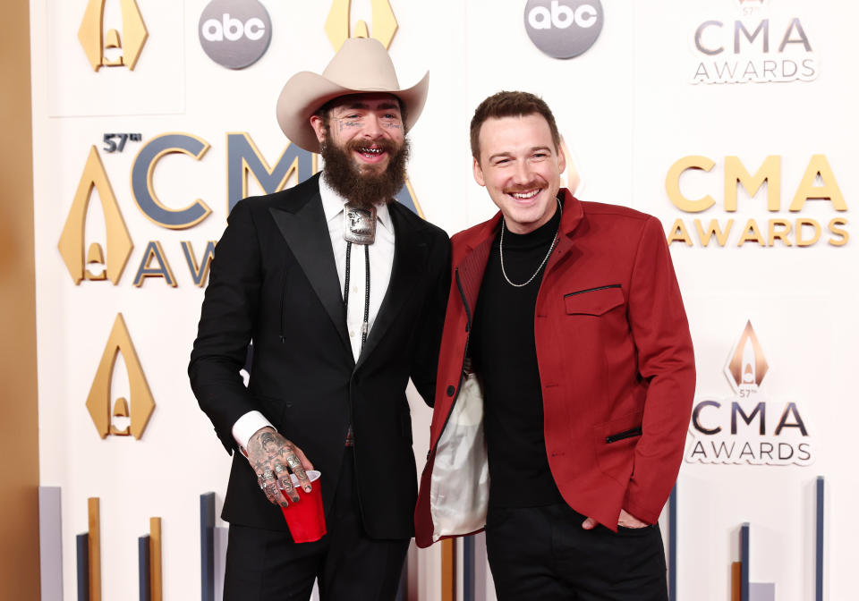 Post Malone and Morgan Wallen smile on the red carpet.