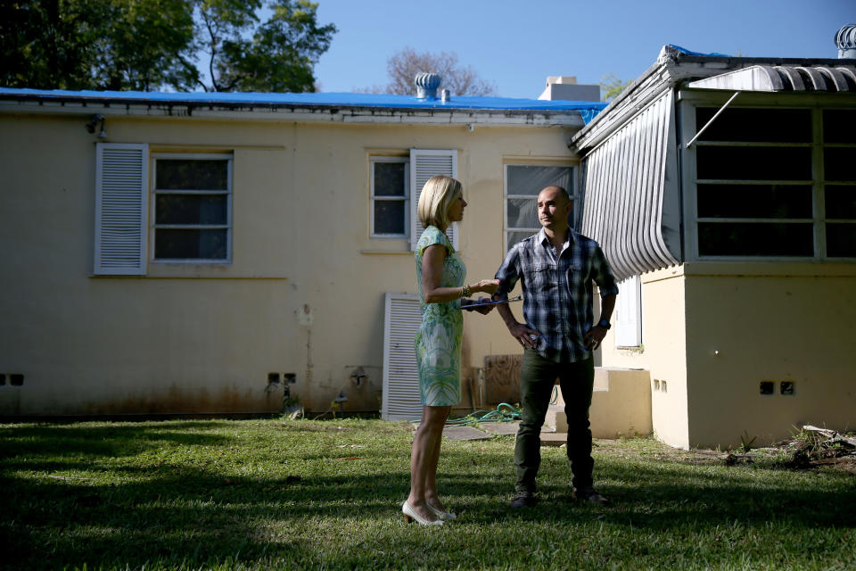 CORAL GABLES, FL - APRIL 22:  Denise Madan (L) , a Real Estate agent with Re/Max, shows prospective buyer Juan Carlos Correa a home that is listed as a short sale as he shops for a house on April 22, 2014 in Coral Gables, Florida. The Federal Housing Finance Agency reported today that home prices rose a seasonally adjusted 0.6% in February, and were up 6.9% from the year-ago period.  (Photo by Joe Raedle/Getty Images)