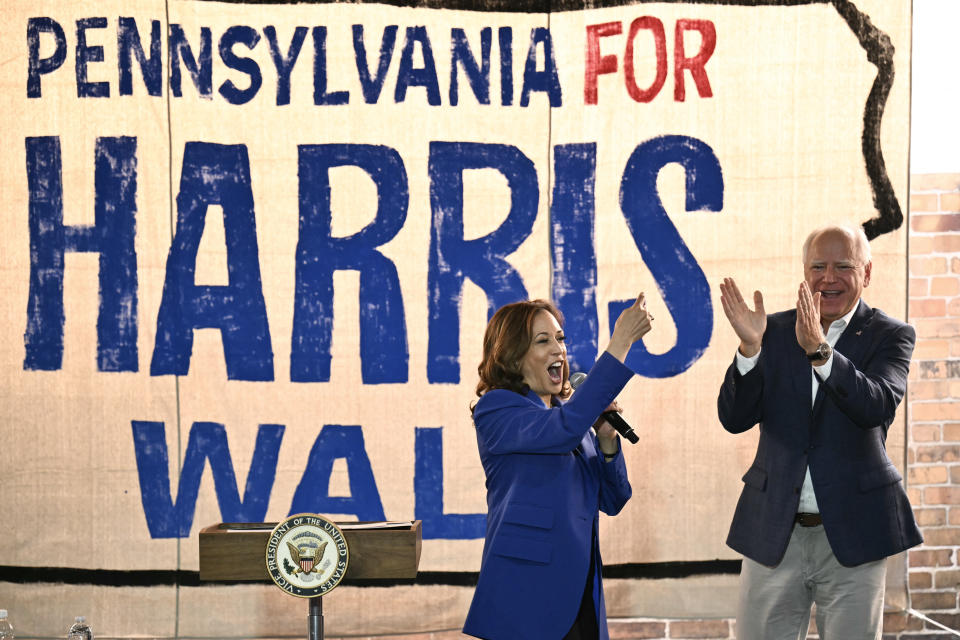 TOPSHOT - US Vice President and Democratic presidential candidate Kamala Harris (L) speaks as her running mate Minnesota Governor Tim Walz looks on during a stop on their campaign bus tour in Rochester, Pennsylvania, on August 18, 2024. Harris embarked on a bus tour of the potentially election-deciding state of Pennsylvania on Sunday, as she keeps up the momentum before her star turn at the Democratic National Convention in Chicago. (Photo by ANGELA WEISS / AFP) (Photo by ANGELA WEISS/AFP via Getty Images)