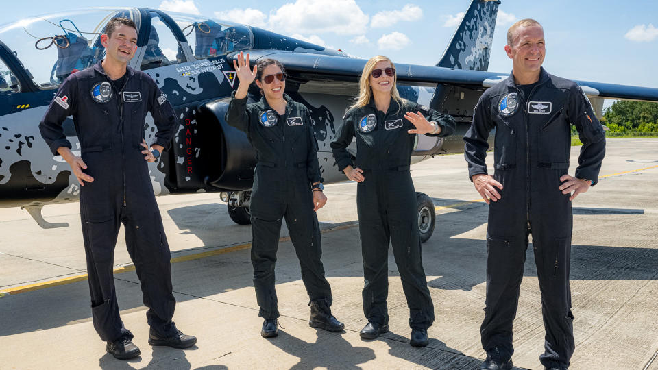 Four private astronauts of Polaris Dawn pose for photos in front of jet plane