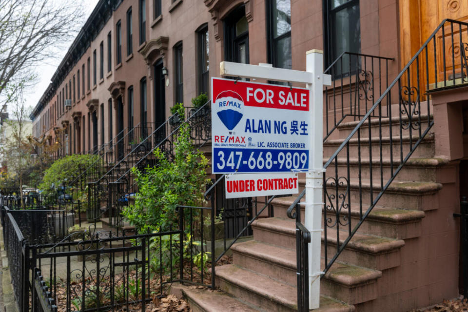 A sign advertising a home for sale is displayed outside of a Brooklyn brownstone on April 11, 2024, in New York City