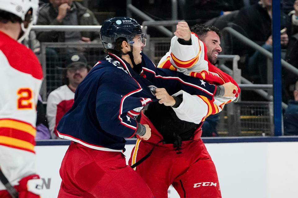 Oct 20, 2023; Columbus, Ohio, USA; Columbus Blue Jackets center Cole Sillinger (4) fights Calgary Flames center Nazem Kadri (91) during the first period of the NHL hockey game at Nationwide Arena.