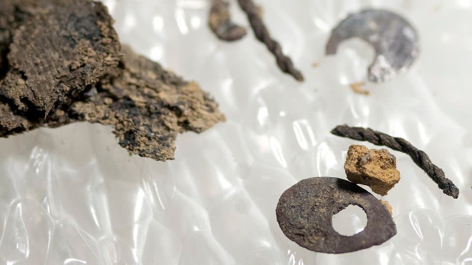 Fabric and sequins uncovered during the excavation of the burials are shown - Jamestown Rediscovery Foundation (Preservation Virginia)