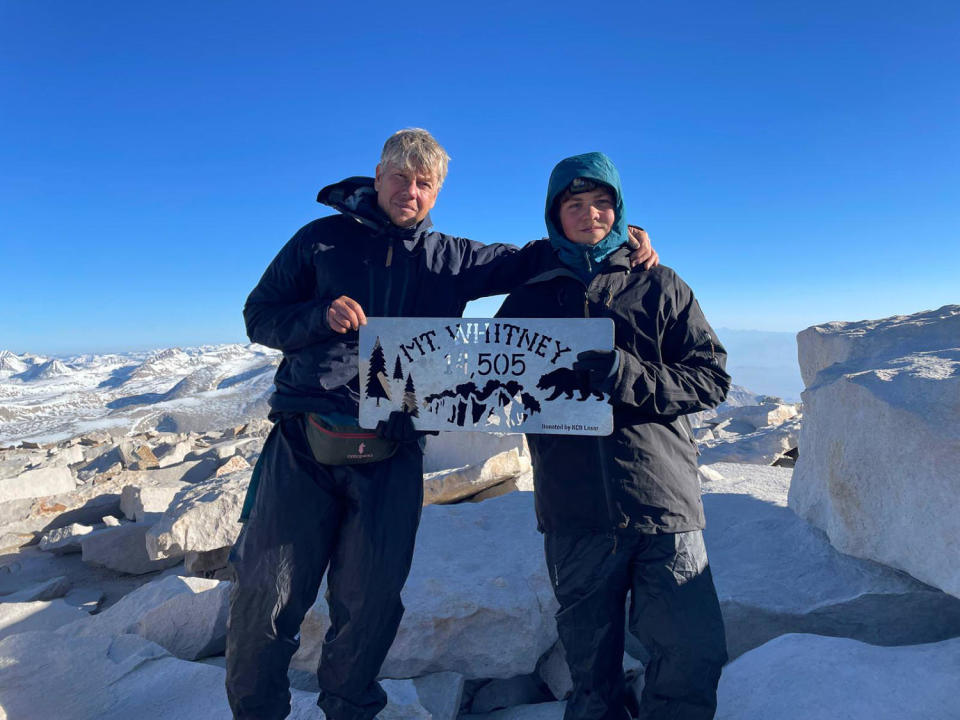 Thijs Koekkoek and his son hold a sign that reads, "Mt Whitney 14,505" (Courtesy Thijs Koekkoek)