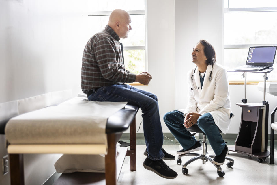 Doctor and senior man discussing treatment in exam room