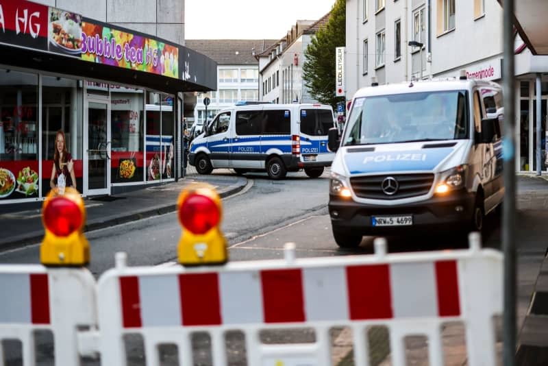 Police cars stand at a cordon after several people were killed and injured in an attack at the city's 650th anniversary celebrations. Christoph Reichwein/dpa